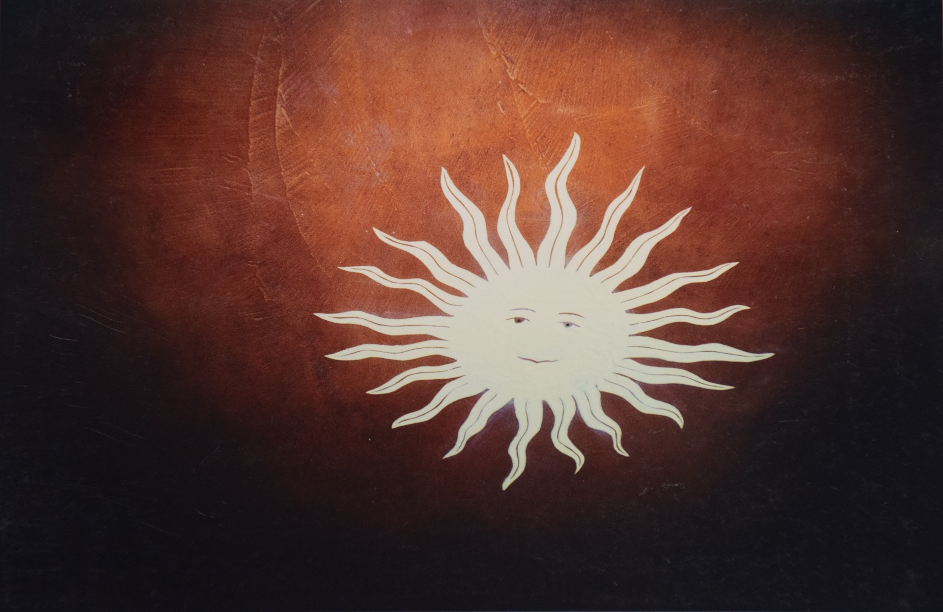 Decorative inlaid concrete floor with sun motif
