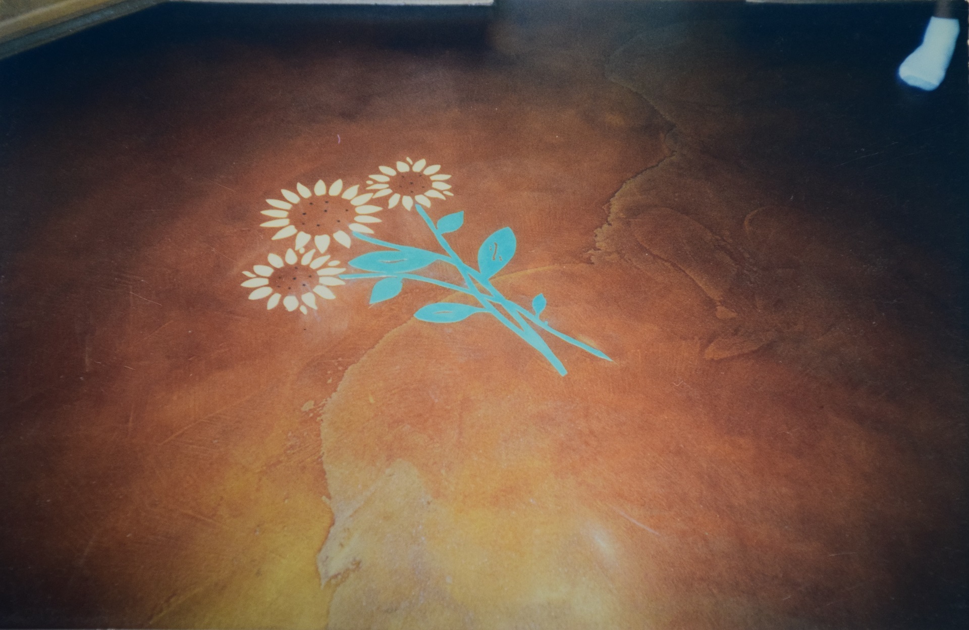 Decorative concrete floor with inlaid sunflower bouquet