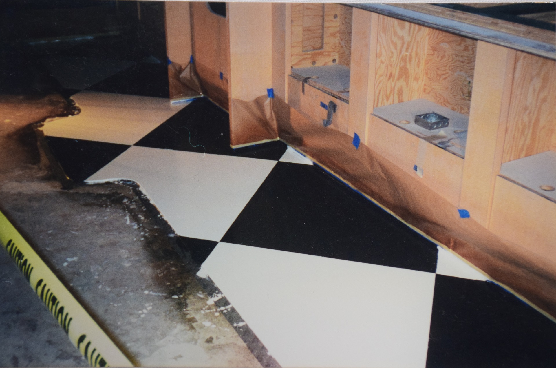 Black and white checker pattern decorative concrete kitchen floor in progress