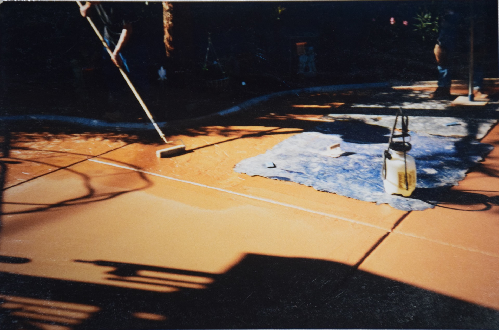 Stamped concrete patio with pool fence and lawn