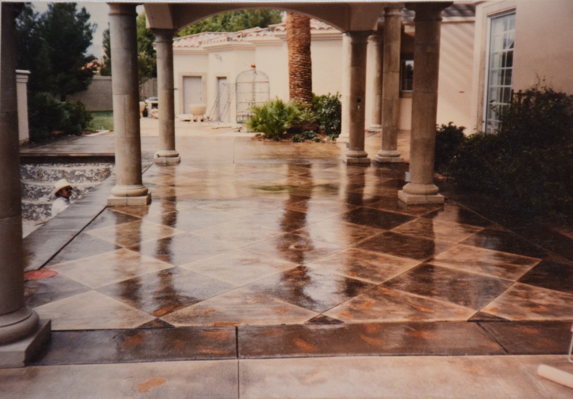 Worker applying concrete stain finish