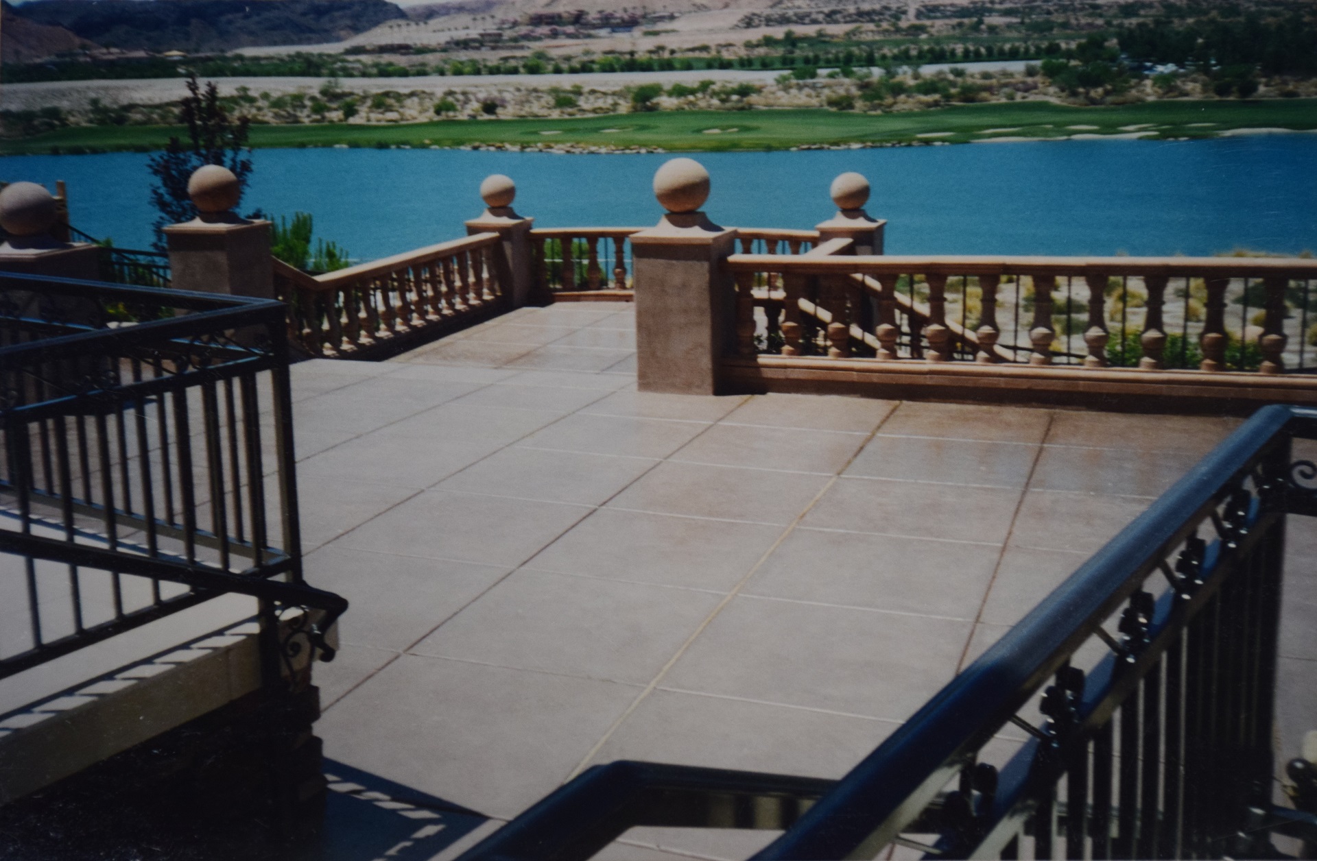 Grand walk-out walkway patio with fire pit and balustrade overlooking water