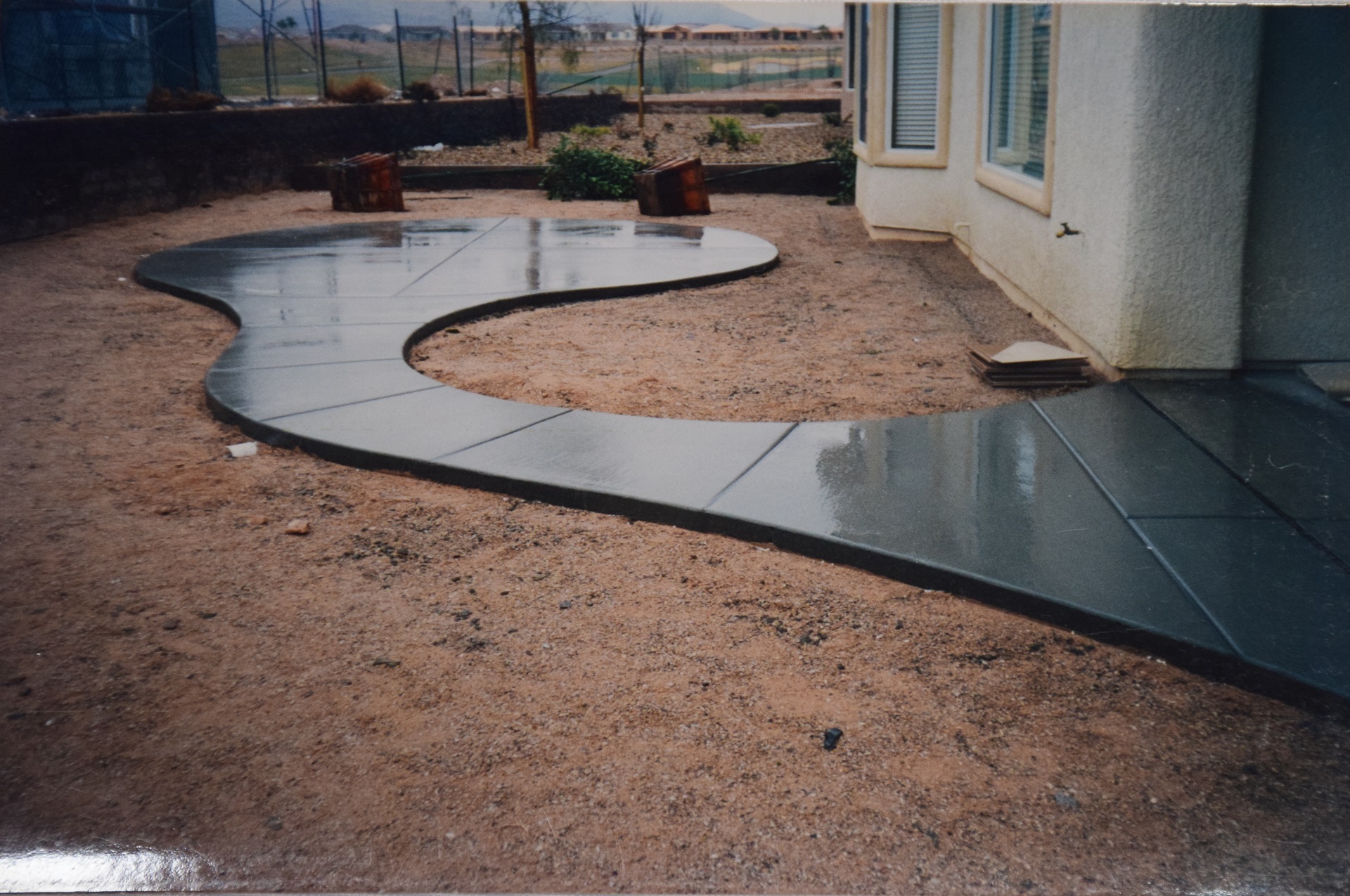Elegant stained concrete walkway leading to front door